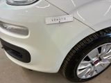 a small white car with a sticker on the front of it