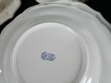 a close up of a white plate with a blue design on it