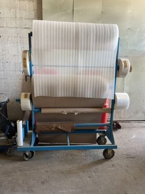 a cart with a roll of fabric on it in a garage