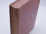 a pink book sitting on top of a white table