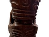 wooden stool made of wood with carvings on top of it