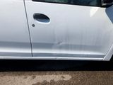 a white car that is parked on the side of the road