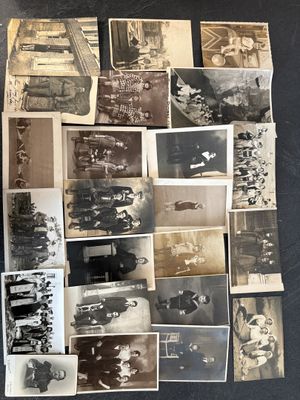 several old black and white photographs of men and women sitting on a table
