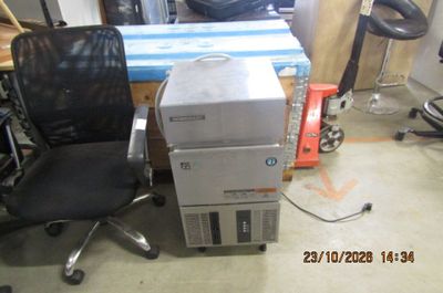 a stack of boxes and a chair in a room