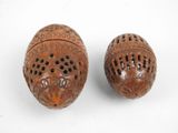 two small wooden objects are sitting on a white surface