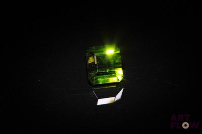 a green light that is shining in the dark