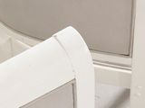 a close up of a white chair with a white seat