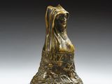 une image représentant une statue en bronze d'une femme assise sur une chaise