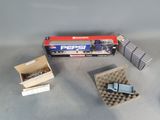 a box of nails and a stapler sitting on a table