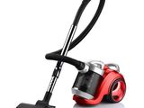 the red vacuum is sitting on the floor next to the black handle