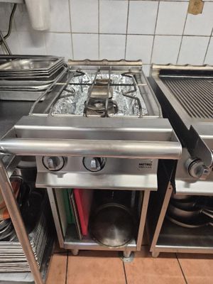 a stove with two burners on top of it in a kitchen