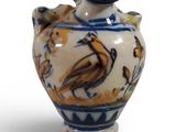a blue and white vase with a bird on it