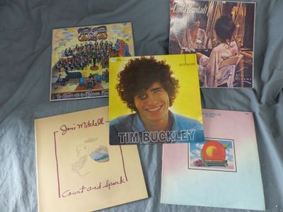 a picture of a bunch of album covers on a bed