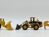 three toy construction vehicles that are lined up on a white surface