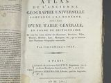 a book open on a table with a black background