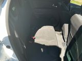 une voiture blanche dont la portière est ouverte, garée sur le bord de la route
