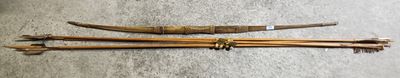 three wooden sticks with metal rings on them sitting on the floor