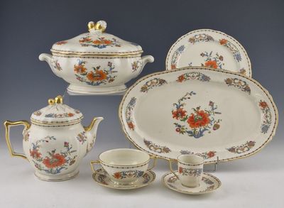 four pieces of china on display on a table