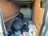bags of garbage in the back of a van