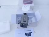 a camera sitting on top of a table next to other items
