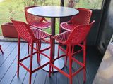 a table and four chairs on the deck of a house