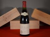 a bottle of wine sitting on a table next to two wooden boxes