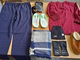a table with a variety of clothing and shoes on it
