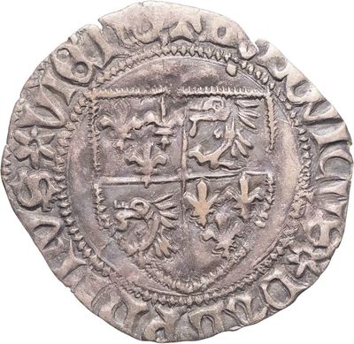 un gros plan d'une pièce d'argent sur laquelle figure un blason