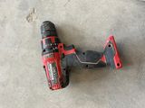 the corded drill is laying on the concrete floor next to a piece of wood