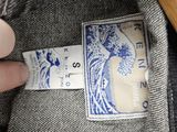a person holding a pair of jeans with a label on it