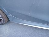 a close up of a car ' s front bumper with a flat tire