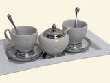 un plateau sur lequel se trouvent trois tasses et une soucoupe