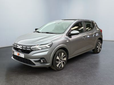 a grey car is parked in a room with a black floor