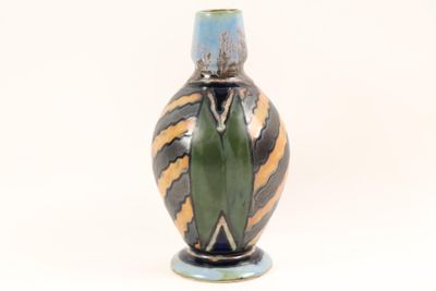 a vase that has a green and yellow design on it