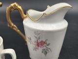 a small pitcher and a small cup on a table