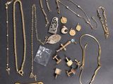 a lot of gold jewelry on a black table