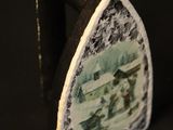 a close up of a piece of metal with a picture on it
