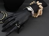 two bracelets and a ring on a mannequin hand