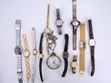 many different types of watches displayed on a white surface