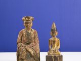 pair of carved wooden figures of a seated man and a seated woman
