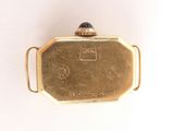 an image of a gold plated pocket watch with a blue stone