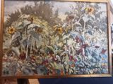 a painting of sunflowers and other flowers on a easel