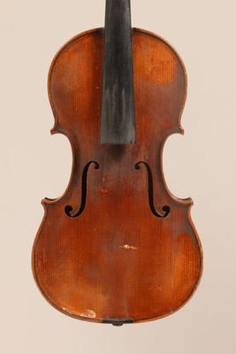 an old violin with a bow hanging from it ' s back