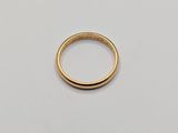 a close up of a gold ring on a white surface
