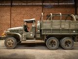 a military truck parked in a building with a brick wall in the background