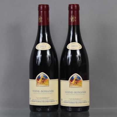 two bottles of wine sitting on top of a glass table
