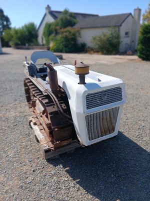 un petit tracteur garé au milieu d'un parking