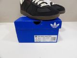 adidas superstar black and white sneakers on top of a blue box