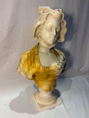 marble bust of a woman in a yellow dress on a white background