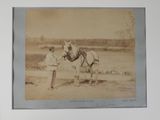 a man standing next to a horse in a field